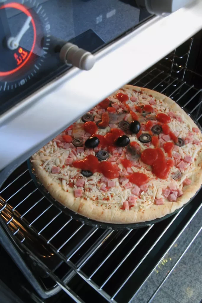 pizza placed in oven for baking