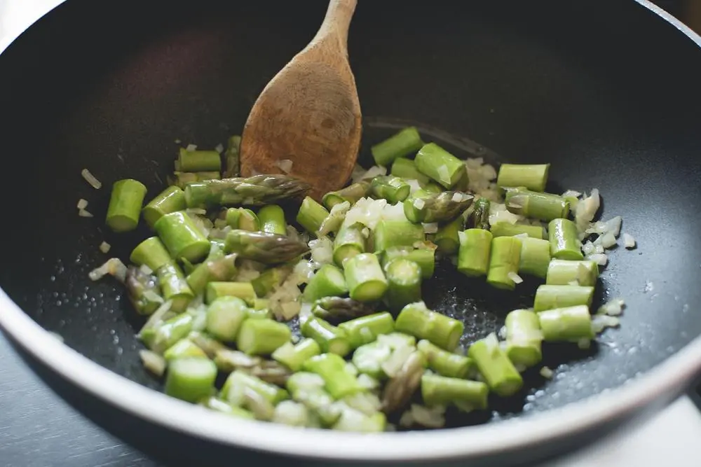 asparagus being sautéed in pan