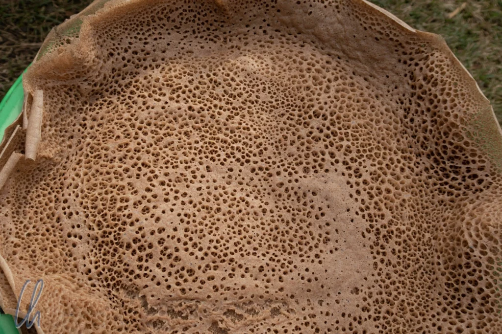 an injera placed flat on a plate.