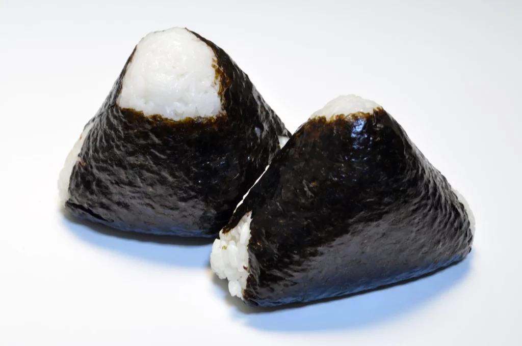 two onigiri covered in nori except for their corners