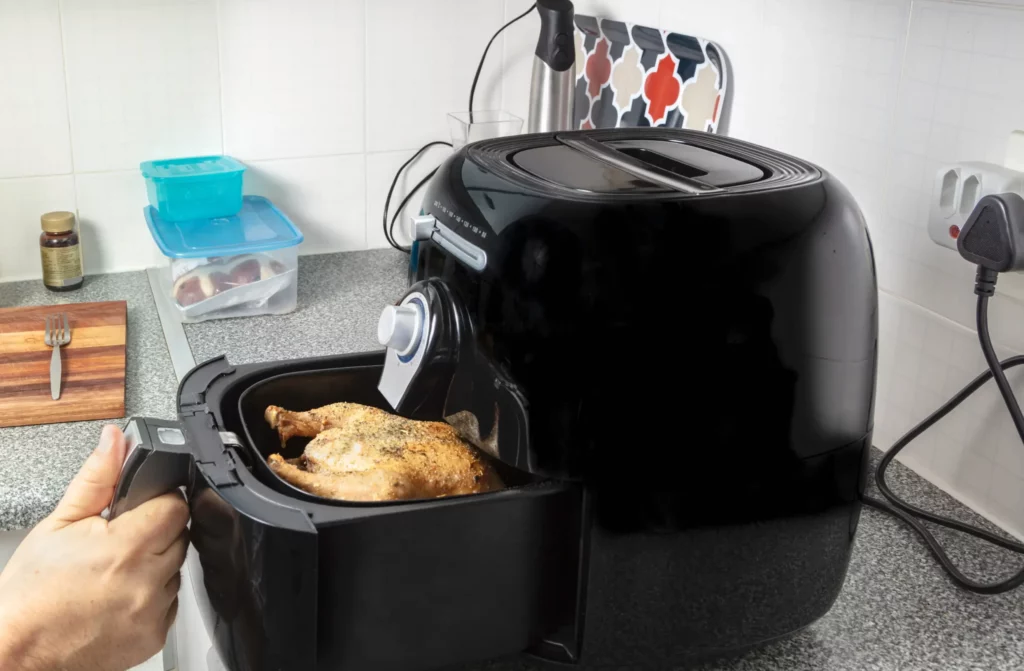 a whole cooked chicken inside an air fryer