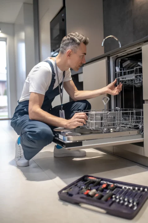 man fixing the dishwasher